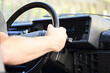 hand on the steering wheel of a car. Close-up Of A Man Hands Holding Steering Wheel While Driving Car. old retro car.