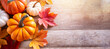 Autumn background with empty space for text. Pumpkin and colorful leaves decorated on wooden desk background. Top view. Studio shooting. Generative AI.