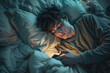 © photo for everything - A male teenager's face under blue lights from a mobile phone. A boy focuses on a smartphone in his hands while lying in bed