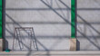 Light and shadow of roof beam structure on surface of concrete wall with green column and scaffolding inside of industrial warehouse building in construction site area