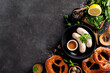 Bavarian white sausages with mustard and pretzel on a black background with copy space.