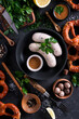 National Bavarian white sausages with mustard and pretzel on a black background, top view.
