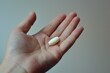 White pill in hand, Male hand with white capsule, Healthcare and medicine