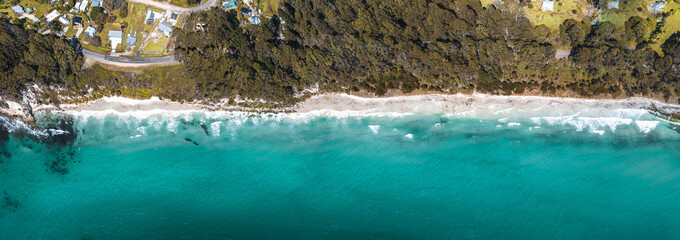 Wall Mural - drone birdseye view of adventure bay, tasmania, australia. blue water with shadows during sunset. be