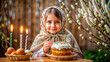 Cute girl in a scarf with Easter cake and Easter eggs