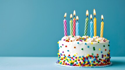 Poster - Colorful birthday cake with lit candles on a blue background. Celebratory mood with sprinkles. Perfect for birthday party invitations. AI