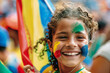Young girl with face paint and bright smile holding colorful flag