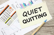 Quiet quitting symbol. sheet of paper with text on financial charts
