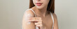 © Pormezz - Body skin care routine concept. Close-up view hands of a young woman applying lotion cream on the shoulder