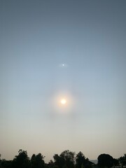 Wall Mural - Blurred image of the sun rising in the sky