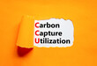 © Dzmitry - CCU Carbon capture utilization symbol. Concept words CCU Carbon capture utilization on beautiful paper. Beautiful orange background. Business ecological Carbon capture utilization concept. Copy space.