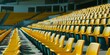 Rows of empty yellow stadium seats