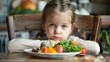 © Ilmi - child has anorexia. little girl in front of food plate, concept child nutritional deficiencies