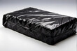 Transportation-ready object secured in black plastic wrap, ideal for logistics and shipping themes