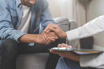 Wall Mural - Psychology, depression. Sad asian young man consulting with psychiatrist while patient counseling mental therapy problem with doctor at clinic. Psychologist encouraging with sick mental health person.