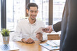 © KMPZZZ - Good job Asian manager business man giving financial reward in an envelope, business letter extra salary to company employee, male worker office hand received premium bonus, getting cheque from boss.