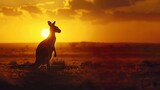 Fototapeta  - A serene scene of a lone kangaroo silhouetted against the backdrop of a vast Australian desert at dusk.