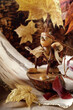 A small gnome made of acorns among the golden autumn leaves. Composition of autumn mood, quiet time.