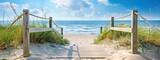 Fototapeta  - A wooden staircase leads to the beach, surrounded by sand dunes and green grasses under clear blue skies.