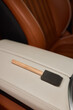 Wooden brush rests on leather car door