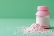 © Serhii - Healthy Baby Talcum Powder on Top of Pink Container with Copy Space on Green Background. Beauty