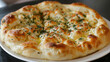 Hearty georgian khachapuri: freshly baked cheese bread garnished with herbs on a white plate