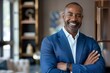 © LukaszDesign - Happy black man, arms crossed or corporate inspiration photo about us or profile image. Smile, confident or mature manager, success mindset, CEO introduction