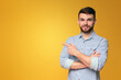 © Prostock-studio - Man Crossing Arms Against Yellow Background