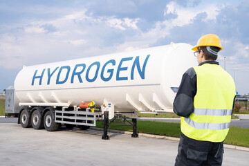 Sticker - Man with digital tablet on a background of hydrogen tank trailer.	