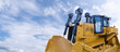 Heavy yellow bulldozer on a background of blue sky.