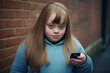 Girl with Down Syndrome holding phone while standing outdoors
