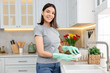 © New Africa - Woman washing dishes in kitchen sink. Cleaning chores