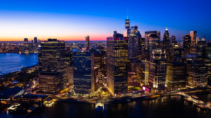 Beautiful city view with multiple lights on. New York panorama from drone photo above the East River. Aerial view.