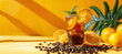 Americano coffee with orange juice in a tall glass with ice and mint on a yellow background with coffee beans