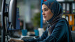 © Kafka - Blue-Hijab Tech Professional Engaged in Multitasking Across Multiple Screens