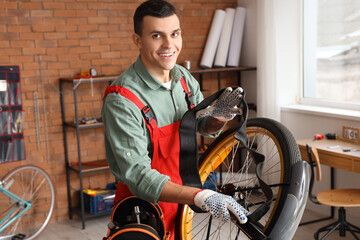 Sticker - Male mechanic repairing bicycle in workshop