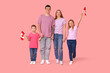 © Pixel-Shot - Beautiful family with flags of Canada on pink background