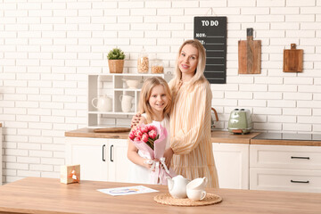 Wall Mural - Cute little girl with her mom and bouquet for Mother's Day at home