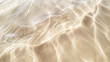 Close-up image capturing the peaceful interaction between clear, shallow waters and the soft sands of a tranquil beach, creating delicate ripples and patterns in the sunlight