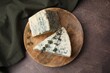 Tasty blue cheese with thyme on brown table, top view