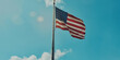 A large U.S. flag hangs on a pole against a blue sky with clouds. American flag illustration, space for copy, text and advertisement. Banner for Independence Day, July 4, Memorial Day