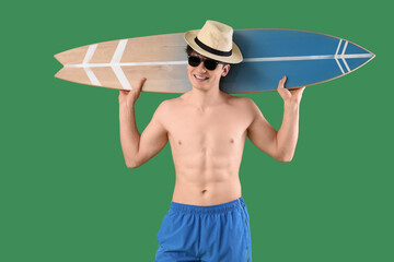 Sticker - Handsome young happy man with surfboard on green background