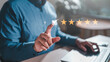 evaluation, feedback, five, management, marketing, opinion, performance, report, reputation, result. A man is giving a thumbs up to a laptop screen with a rating of 5 stars. Concept of satisfaction.