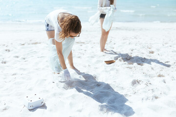 Wall Mural - concerned eco activists on beach collecting trash