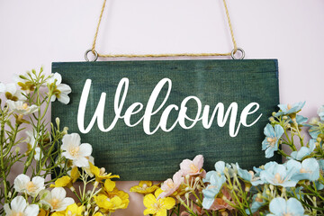 Sticker - Welcome Sign with flowers frame decorate on pink background