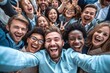 © Chacmool - Group of happy young people in casual clothes taking selfie and smiling while standing in the crowd