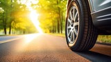 Fototapeta  - Summer tires on the asphalt road in the sun time for summer tires..