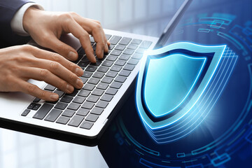 Information security and cyber security. Security measures and secure system. Business man using laptop. Laptop and shield icon.