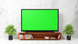 © Midnight Studio - Blank green screen TV on wooden table in living room with white walls. With photocopying space, advertising design, and public relations