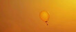 A cinematic shot of a solitary yellow balloon soaring high agnst a backdrop of intense orange, capturing the dynamic energy and freedom of flight.